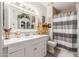 Bathroom with a white vanity, decorative mirror, and a shower with a striped curtain at 7575 E Indian Bend Rd # 1036, Scottsdale, AZ 85250