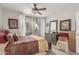 Bright main bedroom with wood-look floors, ceiling fan, and sliding glass doors at 7575 E Indian Bend Rd # 1036, Scottsdale, AZ 85250