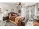 This main bedroom features wood-look floors, a ceiling fan, and a sliding glass door for natural light at 7575 E Indian Bend Rd # 1036, Scottsdale, AZ 85250