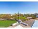 The grassy backyard offers open space and desert views, making it an ideal space for relaxation and activities at 7650 E Culver St, Mesa, AZ 85207