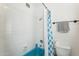 Bright bathroom features a blue tiled bathtub, shower, and essential fixtures at 7650 E Culver St, Mesa, AZ 85207