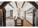 Elegant dining room featuring beamed ceilings, rustic chandelier, and a sliding barn door, perfect for gatherings at 7650 E Culver St, Mesa, AZ 85207