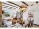 Dining room featuring beamed ceilings, rustic chandelier, and view to the living room, creating an open living concept at 7650 E Culver St, Mesa, AZ 85207