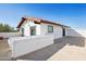 The upper patio of this white home features a red tile roof and offers ample space for outdoor living at 7650 E Culver St, Mesa, AZ 85207