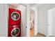 Modern laundry area features a stacked red washer and dryer for space saving convenience at 7650 E Culver St, Mesa, AZ 85207