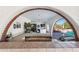 A beautiful archway frames the outdoor space, showcasing the grill, seating area, and inviting pool view at 7650 E Culver St, Mesa, AZ 85207