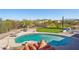 This backyard features a pool, desert landscaping, mountain views, and artificial turf at 7650 E Culver St, Mesa, AZ 85207