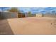 Expansive, enclosed dirt backyard featuring privacy block walls, shed and shade trees at 8038 S 25Th St, Phoenix, AZ 85042