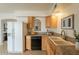 Traditional kitchen with granite countertops, modern appliances, and wood cabinetry at 8038 S 25Th St, Phoenix, AZ 85042