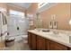 Bathroom featuring double sinks, framed mirror, bathtub with glass door, and great natural light at 8157 E Apache Plumb Dr, Gold Canyon, AZ 85118