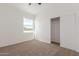 Bright bedroom features a large window, neutral carpet, and a sliding door closet for ample storage at 9504 W Century Dr, Arizona City, AZ 85123