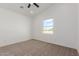 Bright bedroom with plush carpet, neutral walls, and large window offering a view at 9504 W Century Dr, Arizona City, AZ 85123