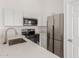 Well-equipped kitchen featuring stainless steel appliances and sleek white cabinets at 9504 W Century Dr, Arizona City, AZ 85123