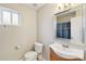 Neat bathroom featuring a single vanity sink, a toilet, and a shower with a curtain at 1055 N Recker Rd # 1253, Mesa, AZ 85205