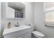 Bathroom features a single sink, mirror, and toilet with accessibility handle at 10816 W Venturi Dr, Sun City, AZ 85351