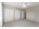 Bright bedroom featuring carpet, ceiling fan, and a closet for ample storage at 10816 W Venturi Dr, Sun City, AZ 85351