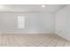 Neutral bedroom with tiled floor and a large window offering plenty of natural light at 10816 W Venturi Dr, Sun City, AZ 85351