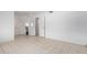 Bedroom with tile floors, neutral paint, closet and entrance to additional room at 10816 W Venturi Dr, Sun City, AZ 85351