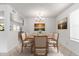 Elegant dining room with modern chandelier, seating for six, and bright natural light at 10816 W Venturi Dr, Sun City, AZ 85351