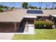 Well-maintained single story home with covered carport, solar panels, walkway with gated entry, and landscaped front lawn at 10816 W Venturi Dr, Sun City, AZ 85351