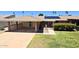 Single story home showcasing a covered carport, solar panels, landscaped front yard, and charming desert foliage at 10816 W Venturi Dr, Sun City, AZ 85351