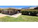 Single story home with carport, landscaped front yard and walkway leading to gated entry with desert foliage at 10816 W Venturi Dr, Sun City, AZ 85351