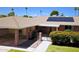 Single story home highlighting a covered carport, solar panels, walkway to gated entry and mature landscaping at 10816 W Venturi Dr, Sun City, AZ 85351
