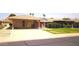 This single-story home offers a carport, quaint front patio, and drought-tolerant landscaping at 10816 W Venturi Dr, Sun City, AZ 85351