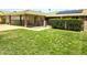 Single-story home showcasing a well-manicured lawn, carport, and gated patio area at 10816 W Venturi Dr, Sun City, AZ 85351