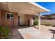 Charming single-story home featuring a covered entrance, desert landscaping, and brick facade with shuttered windows at 10816 W Venturi Dr, Sun City, AZ 85351