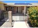 Charming gated front entry featuring desert landscaping and solar panels on the roof at 10816 W Venturi Dr, Sun City, AZ 85351