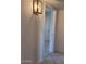 Bright hallway featuring neutral paint, ceramic tile floor, and passage to various rooms in the house at 10816 W Venturi Dr, Sun City, AZ 85351