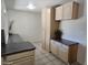Bright kitchen featuring wooden cabinets, tile floors, and spacious countertop at 10816 W Venturi Dr, Sun City, AZ 85351