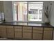 Kitchen with view of back patio featuring lush vegetation visible through sliding window at 10816 W Venturi Dr, Sun City, AZ 85351