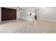 Open-concept living space with decorative brick wall, tile flooring, and a view into the dining and kitchen areas at 10816 W Venturi Dr, Sun City, AZ 85351