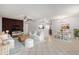 Spacious living room with tile floors, ceiling fan, and open floor plan to dining area at 10816 W Venturi Dr, Sun City, AZ 85351