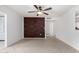 Spacious living room with decorative brick wall and ceiling fan, and tile flooring, perfect for relaxing or entertaining at 10816 W Venturi Dr, Sun City, AZ 85351