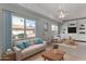 Bright living room with large windows, comfortable seating, and custom built-in shelving at 10816 W Venturi Dr, Sun City, AZ 85351