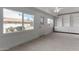 Sunroom with bright windows, neutral carpet, and white built-in storage cabinets at 10816 W Venturi Dr, Sun City, AZ 85351