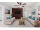 Bright living room with modern brick accent wall, neutral furniture, and stylish decor at 10816 W Venturi Dr, Sun City, AZ 85351