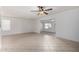 Bright and airy living room features tile flooring, a ceiling fan, and lots of natural light from a front-facing window at 10816 W Venturi Dr, Sun City, AZ 85351