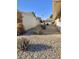 Low-maintenance side yard with gravel, drought-resistant plants, and walkway between homes at 10816 W Venturi Dr, Sun City, AZ 85351