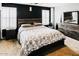 Stylish bedroom with dark accent wall, plush bedding, and modern furniture at 10825 W El Cortez Pl, Peoria, AZ 85383