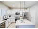Well-lit kitchen with white cabinets, stainless steel appliances, a kitchen island, and tiled backsplash at 10825 W El Cortez Pl, Peoria, AZ 85383