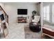 Comfortable living room with a decorative rug, console table, and shuttered windows at 10825 W El Cortez Pl, Peoria, AZ 85383