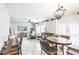 Spacious living area with a dining table, comfortable seating, and modern decor, illuminated by natural light at 10825 W El Cortez Pl, Peoria, AZ 85383