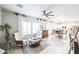 Bright, open-concept living room featuring tile floors and a view into the kitchen at 10825 W El Cortez Pl, Peoria, AZ 85383