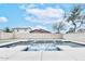 Backyard pool area surrounded by a block fence, landscaping, and a vibrant blue sky at 10825 W El Cortez Pl, Peoria, AZ 85383