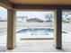 Covered patio view shows the pool, blue sky, trees, and block fence at 10825 W El Cortez Pl, Peoria, AZ 85383