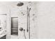 Up close picture of shower head and marble style tile at 10825 W El Cortez Pl, Peoria, AZ 85383